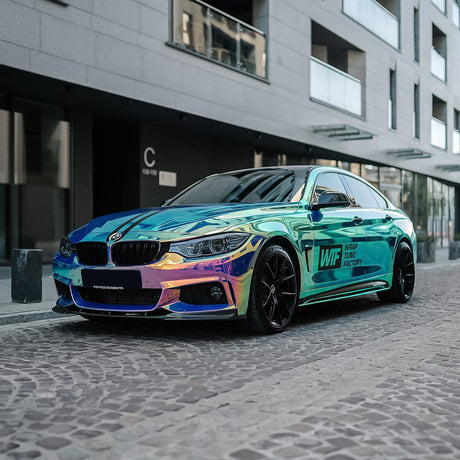 BMW wrapped in TeckWrap Chrome Frozen Berry (MCH08) vinyl, radiating vibrant aqua, purple, and green mirror effect