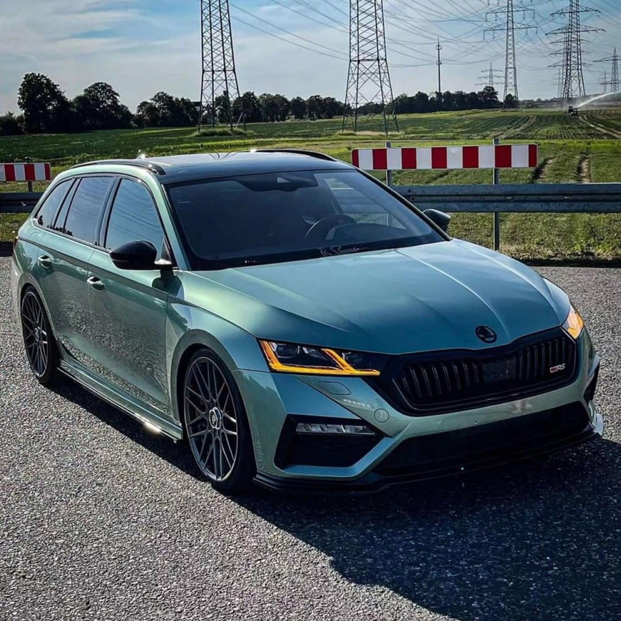 Front-angle view of a vehicle wrapped in Teckwrap Gloss Antique Green (HM16-HD), accentuating its stunning gloss finish and rich, antique-inspired color.