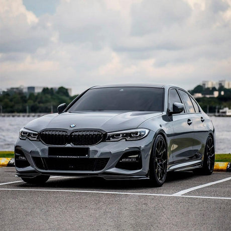 BMW fully wrapped in TeckWrap Gloss Battleship Grey (CG20-HD) vinyl, parked outdoors, illustrating the elegant high-gloss finish and sleek battleship grey tone.