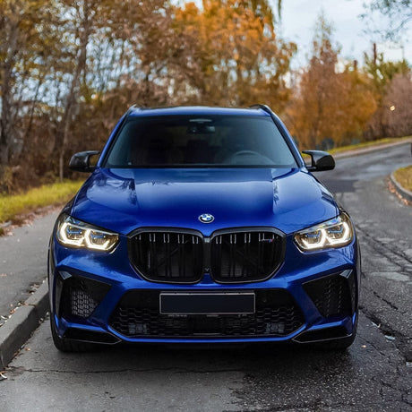 Front view of a BMW wrapped in TeckWrap Glossy Deep Blue (RB02-HD) Vinyl, emphasizing its bold, luxurious appearance and elegant color depth.