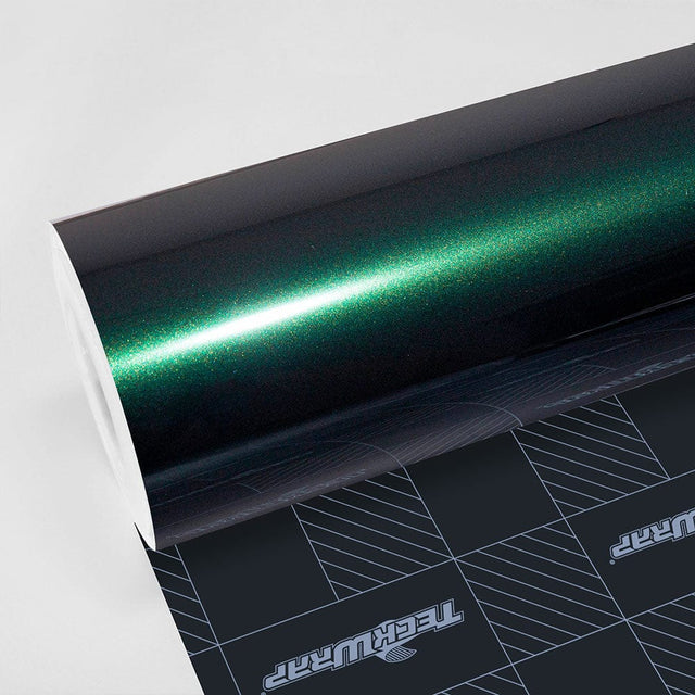 Close-up of TeckWrap Gloss Green Black (HM07-HD) vinyl wrap showcasing a rich, deep green finish with subtle black undertones and a glossy sheen.