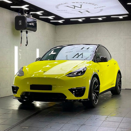 Tesla wrapped in TeckWrap Grape Green (CG42-HD) Vinyl Wrap, emphasizing the vibrant glossy appearance in a modern showroom