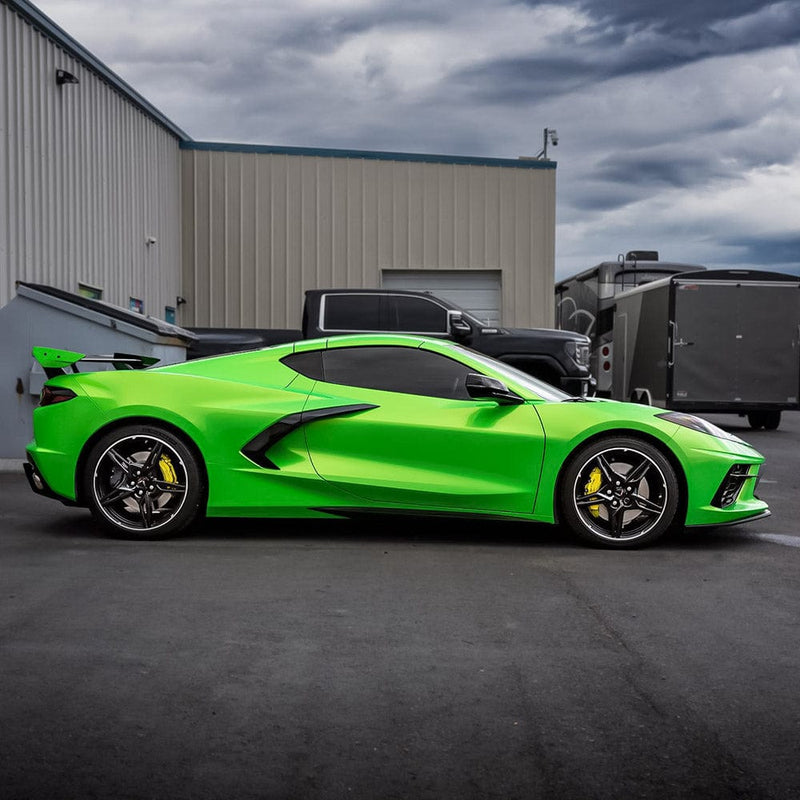 Side view of a Corvette wrapped in vibrant Kelly Green (RB22-HD) gloss vinyl, emphasizing its dynamic contours and sporty silhouette.