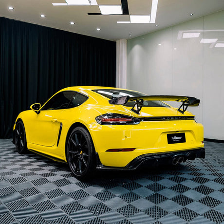 Rear angle of a Porsche wrapped in TeckWrap Louvre Yellow (CG43-HD) Gloss Vinyl, displaying its luxurious gloss and sporty appearance
