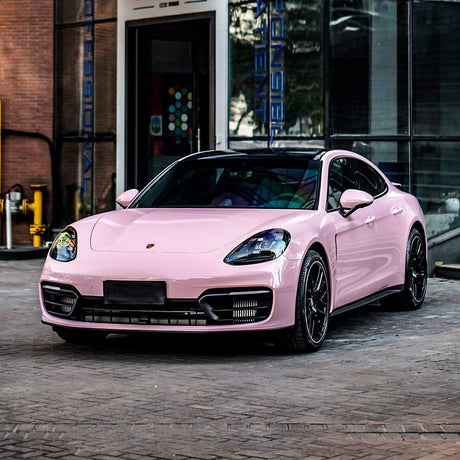 Porsche wrapped in TeckWrap Millennial Pink Gloss Vinyl, demonstrating a sophisticated, sleek appearance with a vibrant pastel pink finish.
