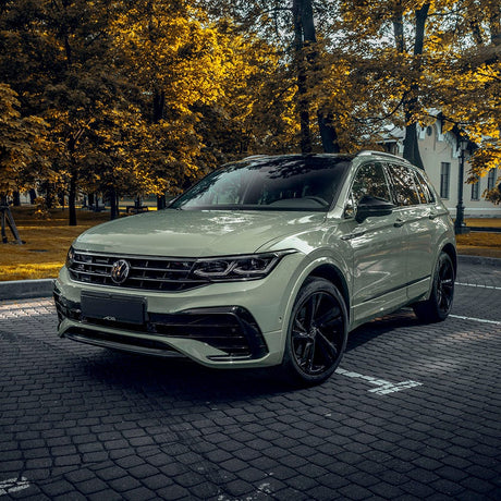 Volkswagen Tiguan SUV fully wrapped in TeckWrap Moss Green CG23-HD Glossy Vinyl parked outdoors, reflecting a premium olive green sheen.