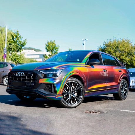 Luxury SUV fully wrapped with TeckWrap Gloss Rainbow Vortex (RD11-HD) Vinyl Wrap, beautifully displaying its dynamic rainbow colors, enhancing the vehicle’s bold and eye-catching appearance outdoors.