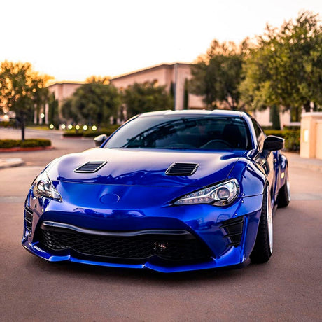 Sporty car elegantly wrapped with TeckWrap Royal Blue (GAL19-HD) Gloss Vinyl, showcasing a vibrant blue glossy finish that accentuates the vehicle's aggressive contours and highlights its sporty aesthetics.