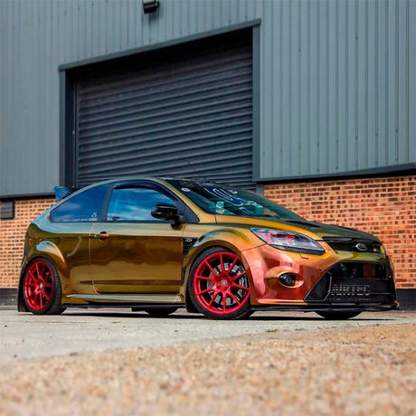 Ford sports car wrapped in TeckWrap Ruby Gold (RD13-HD) Gloss Vinyl, emphasizing sleek curves and color-changing finish with striking gold and ruby tones.