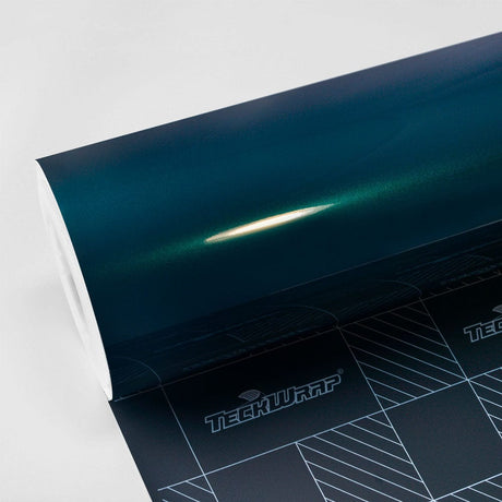 Close-up of Teckwrap Gloss Sherwood Green (HM14-HD) vinyl wrap showcasing its deep teal hue with a glossy finish, highlighted by studio lighting.