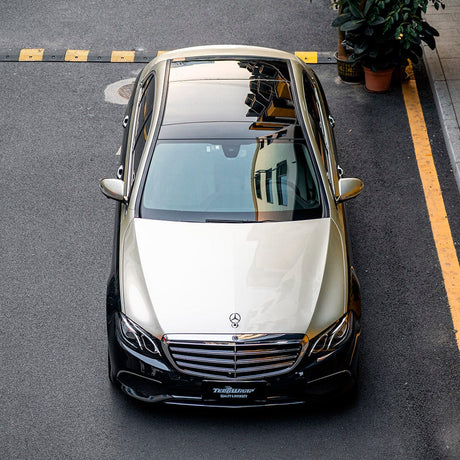 Luxury Mercedes-Benz wrapped in Silver Fern (RB31-HD) Gloss vinyl by TeckWrap, viewed from above to emphasize the elegant glossy silver finish.