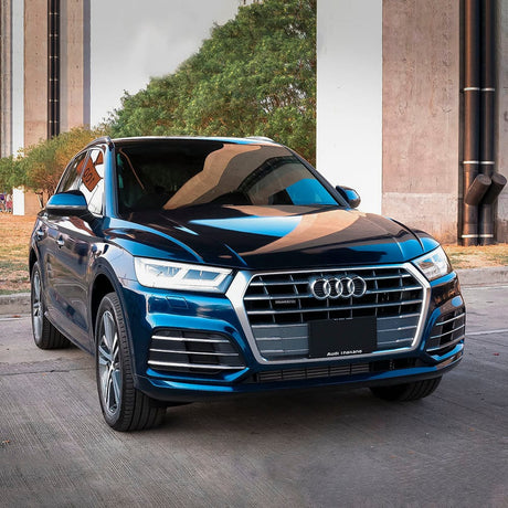 Audi SUV Front View in Space Blue Gloss Wrap – An Audi SUV prominently featuring the Space Blue (GAL14-HD) TeckWrap vinyl wrap, demonstrating the vinyl's impressive gloss and vivid color that reflects the environment stylishly.