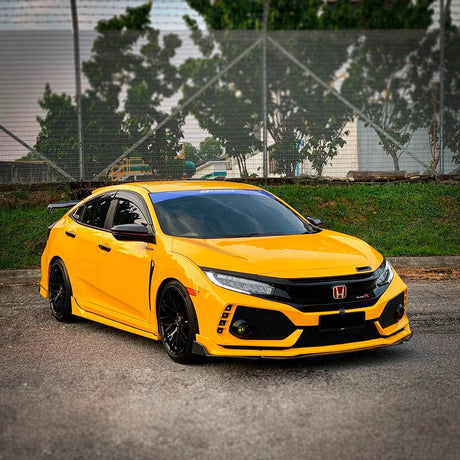 Sporty Honda Civic wrapped in TeckWrap Sunflower Yellow (CG12-HD) gloss vinyl, demonstrating a bold, eye-catching appearance.