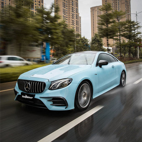 Mercedes-Benz coupe in motion, featuring the vibrant Yacht Blue (CG28-HD) glossy vinyl wrap by TeckWrap, accentuating the dynamic contours and high-end aesthetics of the vehicle.