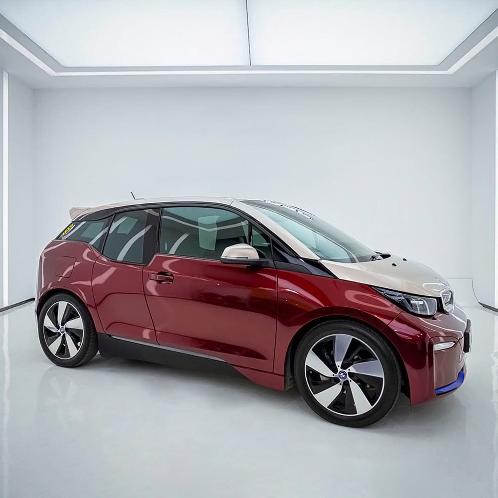 BMW i3 elegantly wrapped in Velvet Red (GAL30-HD) High Glossy vinyl wrap, displaying a luxurious, reflective finish enhancing the vehicle's contemporary style.