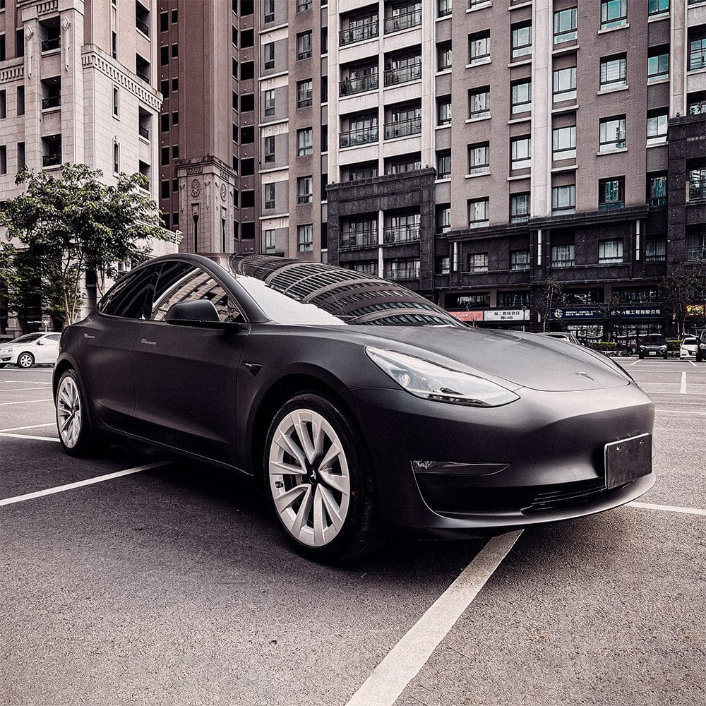 Side profile of Tesla Model 3 featuring a TeckWrap Deep Black SCM01 matte vinyl car wrap