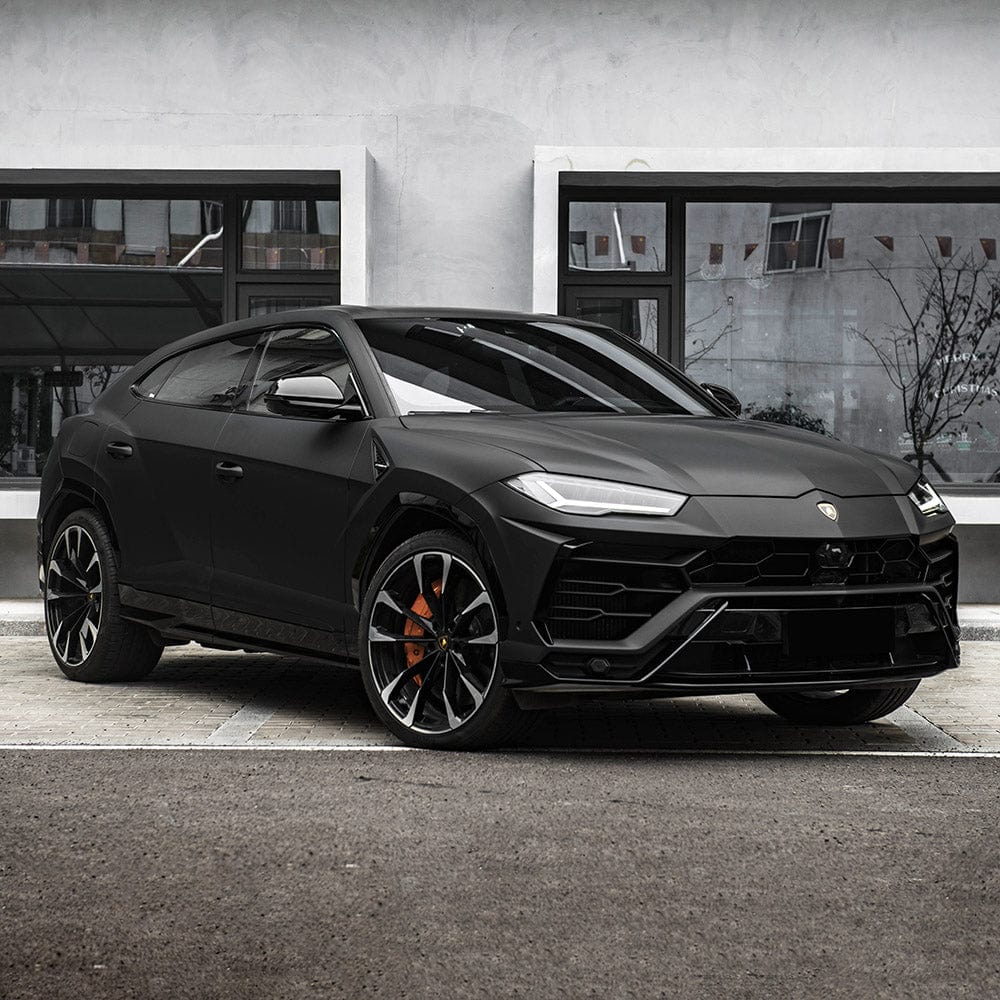Lamborghini SUV fully wrapped in TeckWrap Deep Black SCM01 matte vinyl parked on modern pavement