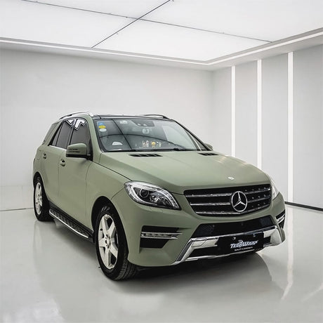 Mercedes-Benz SUV wrapped in TeckWrap Matte Lizard Grey vinyl film, featuring full body coverage in a professional studio setup.