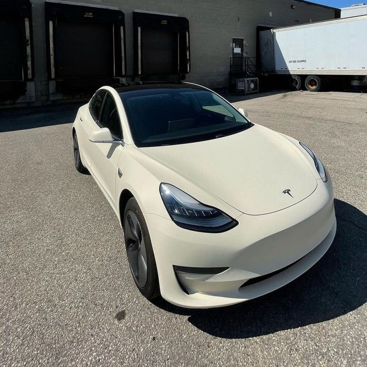 Tesla Model 3 elegantly wrapped in Vanilla Cream (SCM26-R) Matte Vinyl, presenting a sophisticated and clean look