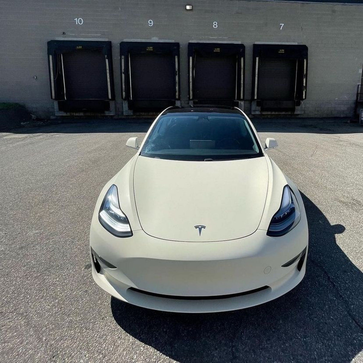 Front view of Tesla Model 3 showcasing the seamless Vanilla Cream (SCM26-R) Matte Vinyl Wrap by TeckWrap