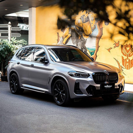 BMW SUV wrapped in TeckWrap Charcoal Grey Satin Vinyl, presenting a sophisticated matte appearance with subtle reflective highlights.