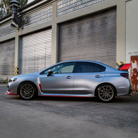 Side view of a Subaru sedan wrapped in TeckWrap Gunmetal Grey satin vinyl, highlighting the subtle metallic sheen.