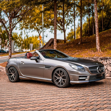 Mercedes convertible elegantly wrapped in TeckWrap Gunsmoke Grey (ECH02) Satin Vinyl, demonstrating luxury and refinement in outdoor settings.