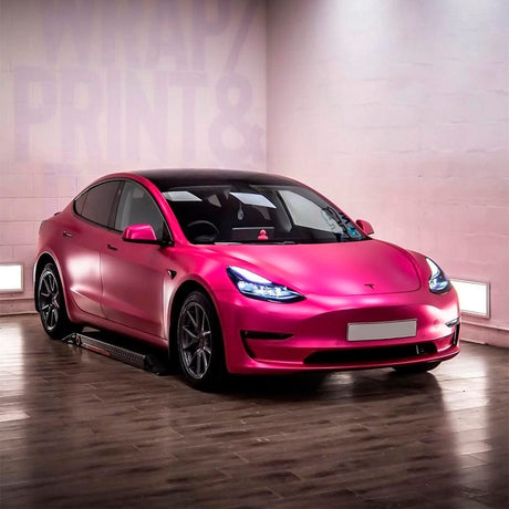 Tesla Model 3 wrapped in TeckWrap Hot Pink (VCH404-S) Satin Vinyl Wrap, highlighting its luxurious satin texture and striking pink appearance under indoor lighting.