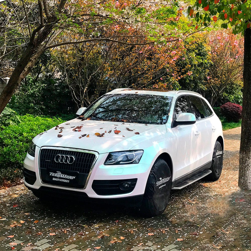 Front and side view of an Audi wrapped in Teckwrap Matte Aurora White (DCH02) vinyl, highlighting the wrap’s stylish matte finish with soft iridescent hues.