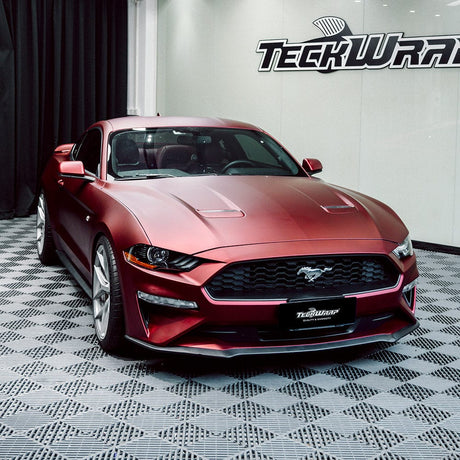 Ford Mustang fully wrapped in TeckWrap Satin Metallic Oxide Red (SMT18) vinyl with a satin metallic finish on display at a wrap studio.