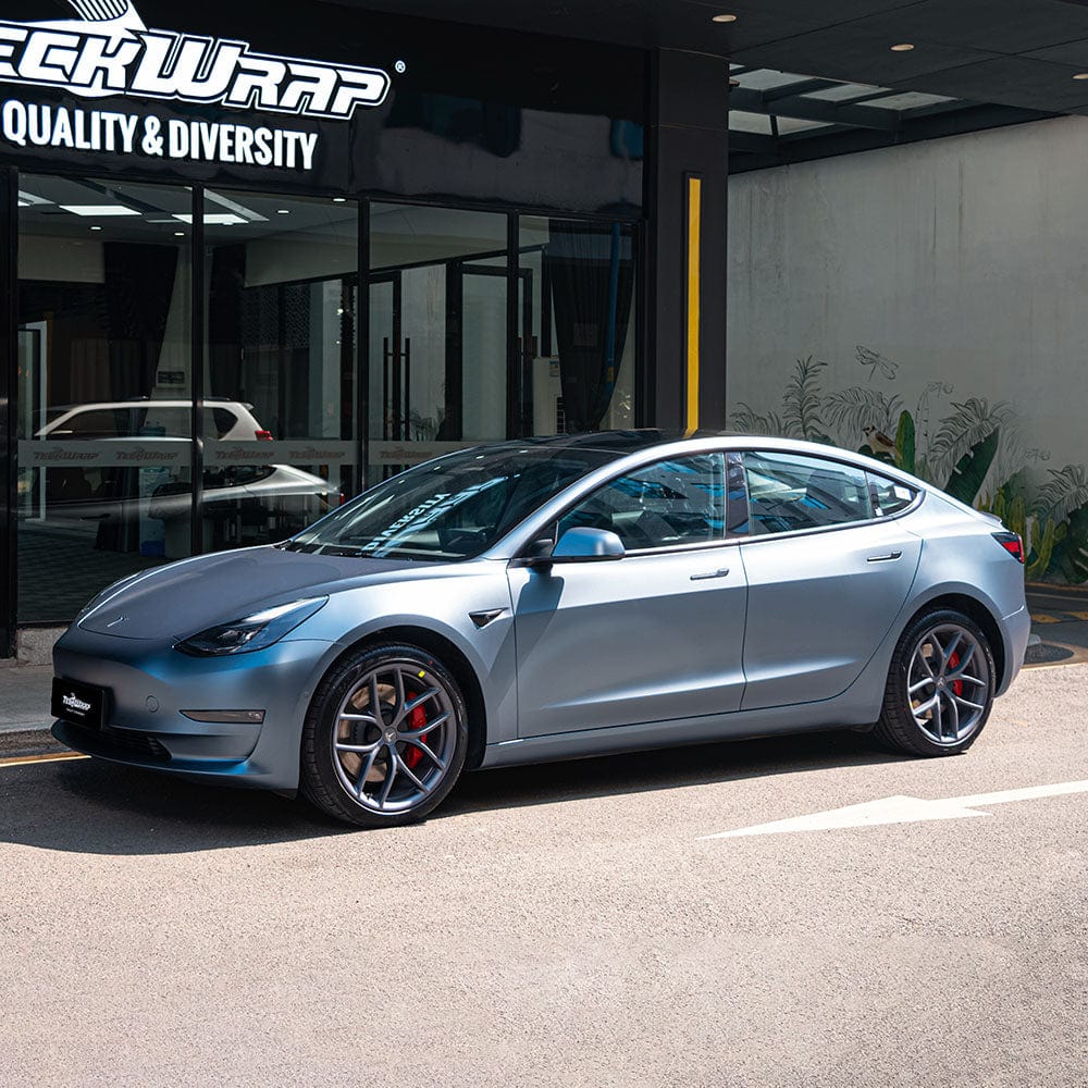Tesla Model 3 fully wrapped in TeckWrap SMT19 satin silver blue vinyl showcasing sleek side profile