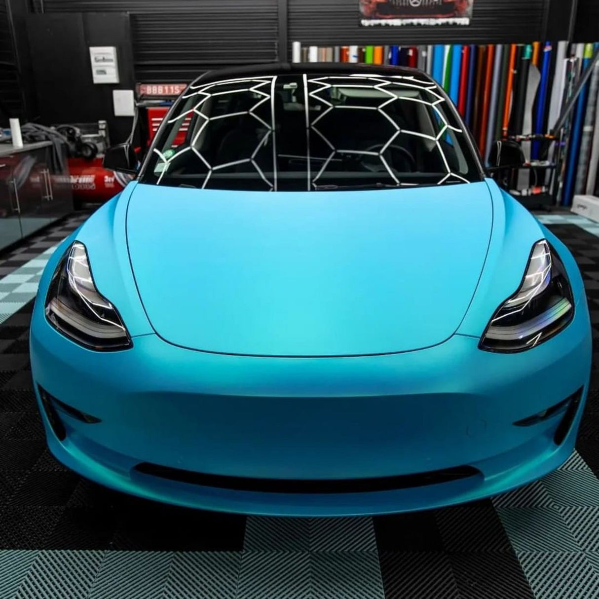 Close Front-End View of a Tesla Model 3 Wrapped with TeckWrap Surf Blue (SMT11) Satin Vinyl, Clearly Illustrating the Flawless Satin Finish and Eye-catching Blue Color