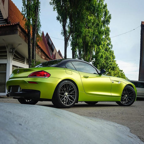 BMW Z4 wrapped in TeckWrap Yellow Lime satin vinyl film, showcasing bright lime finish with matte gloss and sporty elegance.
