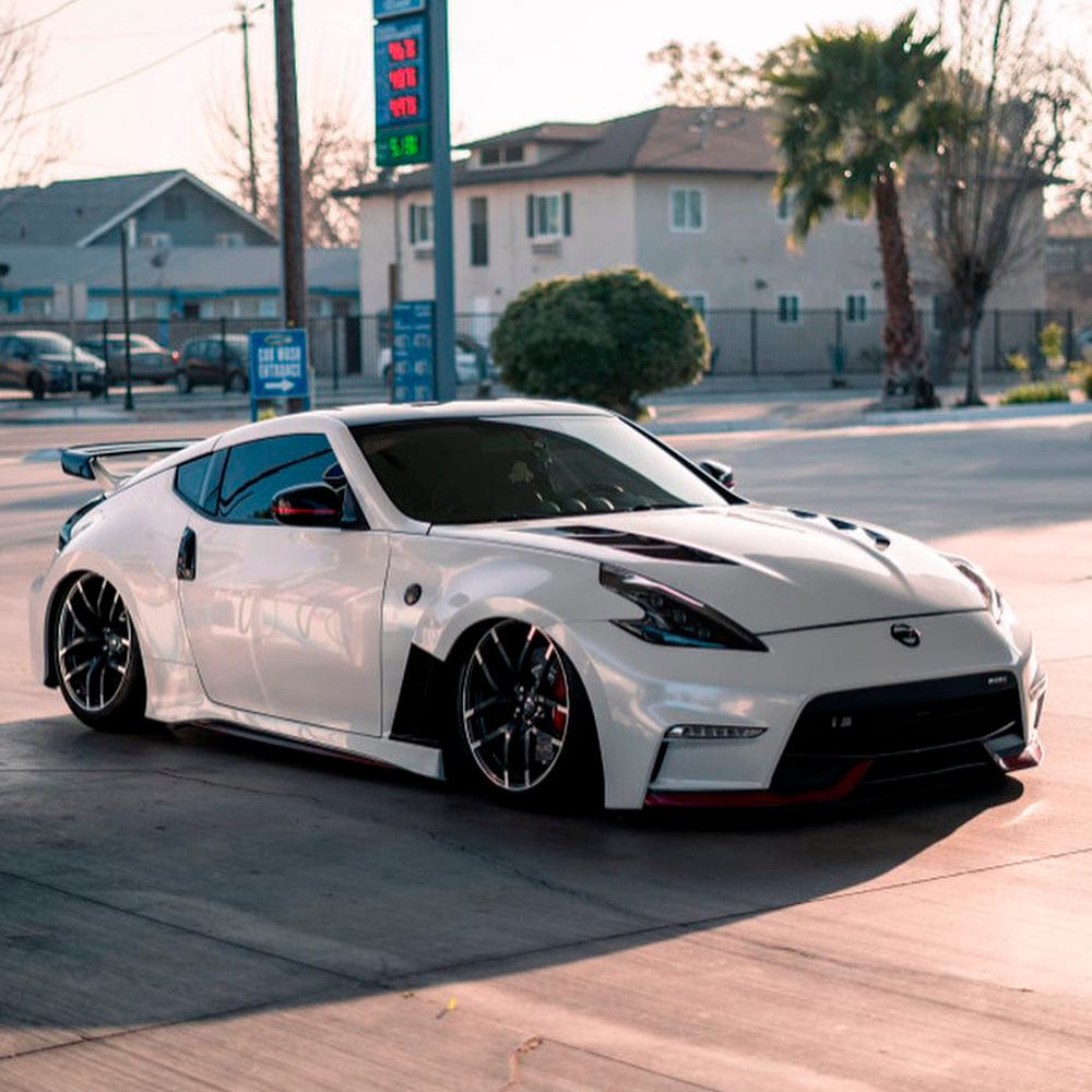 Side view of a sports car wrapped in Teckwrap White Pearl (CK522-HD) vinyl wrap, clearly highlighting its luxurious glossy texture and mesmerizing white chameleon pearl effect.