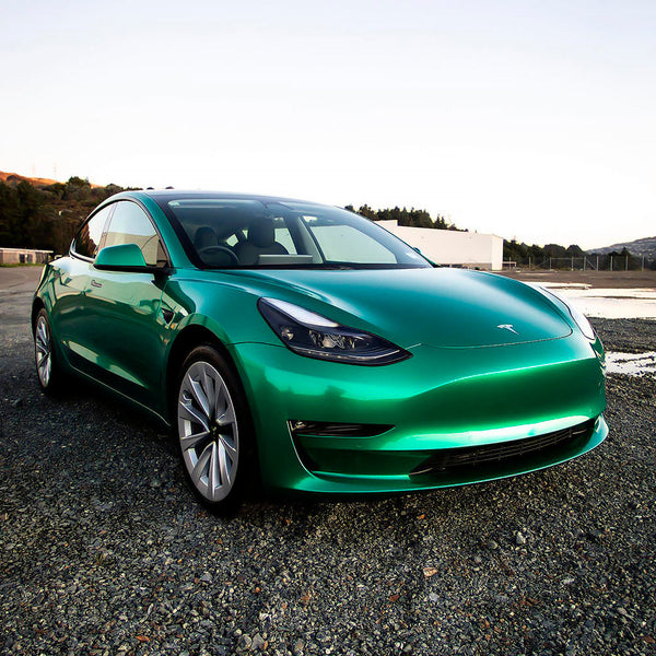 Tesla Model 3 wrapped in gloss metallic green vinyl