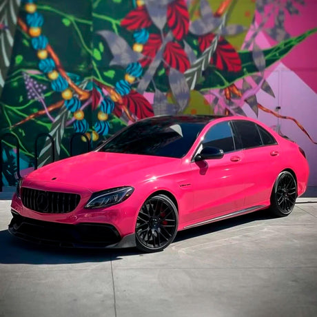Mercedes C-Class wrapped in Berry Red (CG49-HD) gloss vinyl with black wheels and mural background