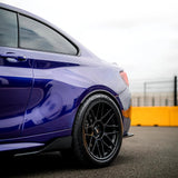 Close-up rear quarter panel of BMW featuring TeckWrap Deep Blue RB02-HD vinyl wrap with mirror-like shine