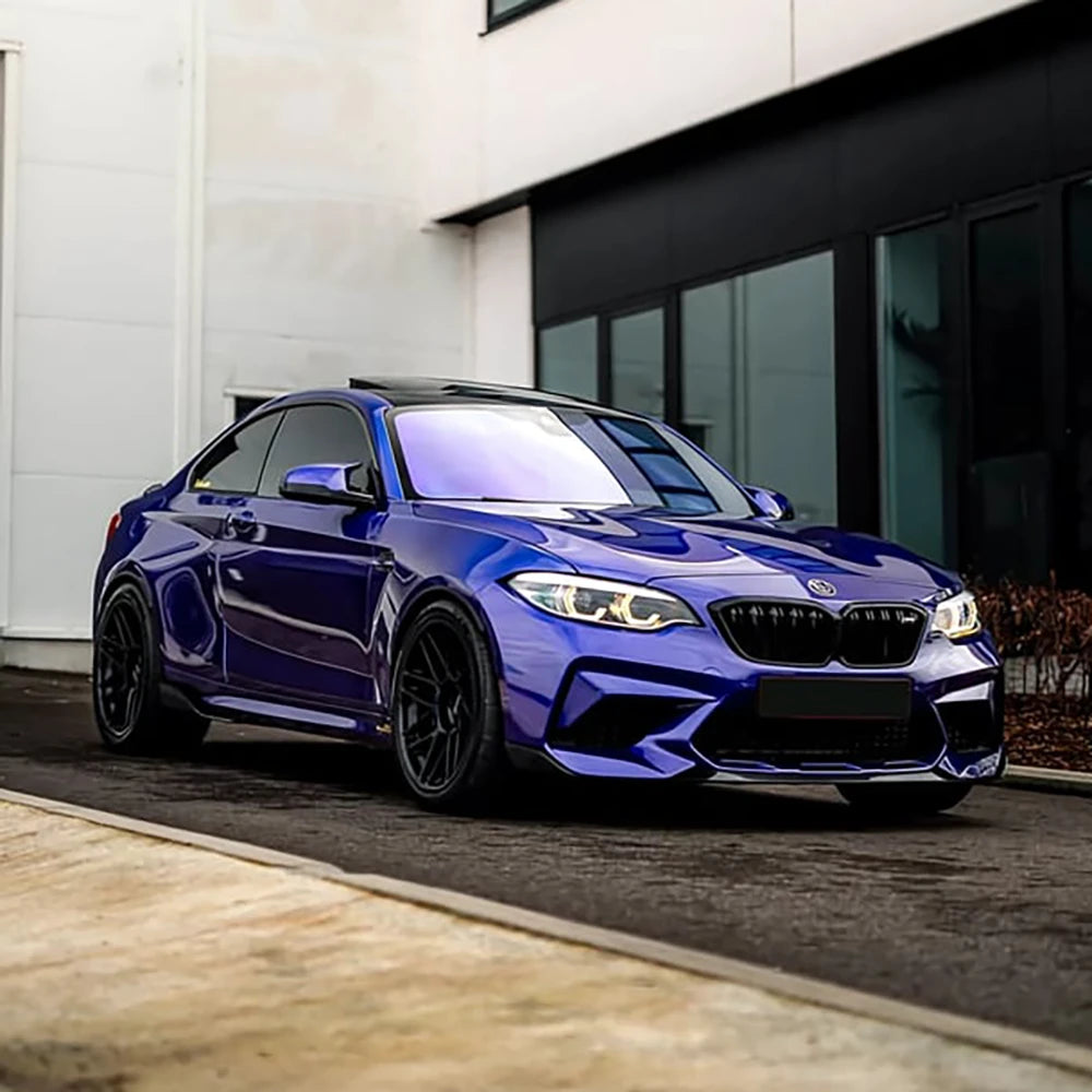 Side angle view of BMW sports car customized with Deep Blue RB02-HD high-gloss vinyl wrap by TeckWrap