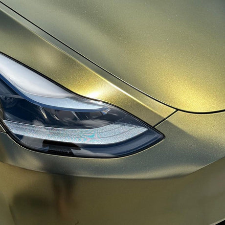 Close-up of headlight and fender wrapped in Greenfinch Gold HM09 satin metallic vinyl by TeckWrap