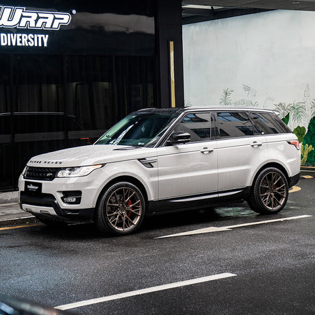 Range Rover SUV with a TeckWrap Vintage Grey (CG47-HD) gloss vinyl wrap, parked in front of TeckWrap Building