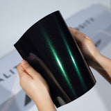 TeckWrap A5 Metallic PPF sample with black base and emerald green reflective streaks