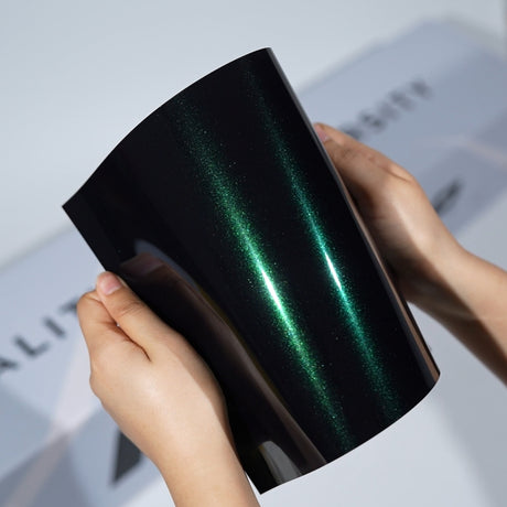 TeckWrap A5 Metallic PPF sample with black base and emerald green reflective streaks