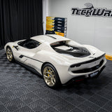 Ferrari 296 GTB wrapped in gloss vanilla wrap with custom stickers, backside view