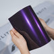 Hands holding a TeckWrap Phantom Purple Color-Shift PPF sample (CPX418), displaying its glossy midnight-violet finish and premium color-shift paint protection surface.