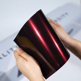 TeckWrap A5 Metallic Paint Protection Film sample in dark burgundy red with glossy shine