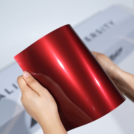 TeckWrap A5 Metallic PPF sample in bright red with smooth high-gloss reflection