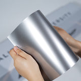 TeckWrap A5 Metallic Paint Protection Film sample in bright silver with fine metallic flakes
