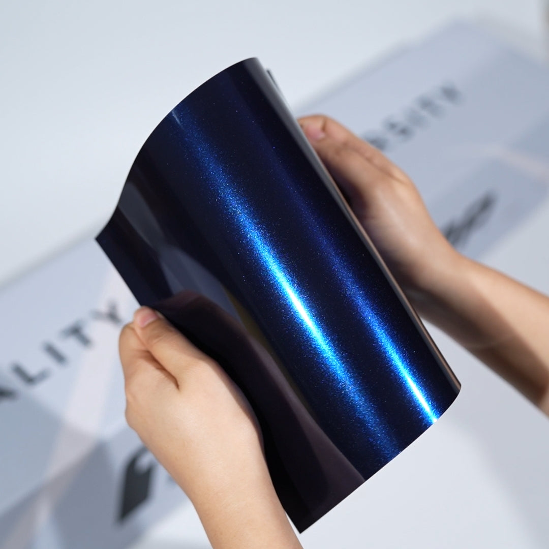 TeckWrap A5 Metallic Paint Protection Film sample in midnight blue with vivid blue pearl highlight