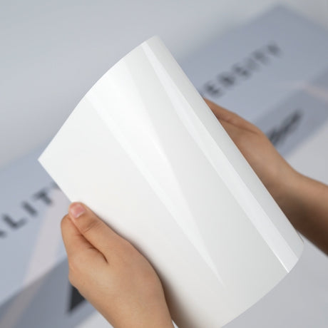 Gloss white TeckWrap A5 Pure Color Paint Protection Film sample held in hands