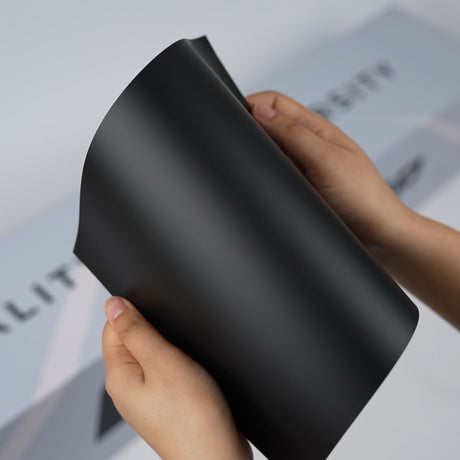 TeckWrap A5 Pure Color Paint Protection Film sample in matte black finish